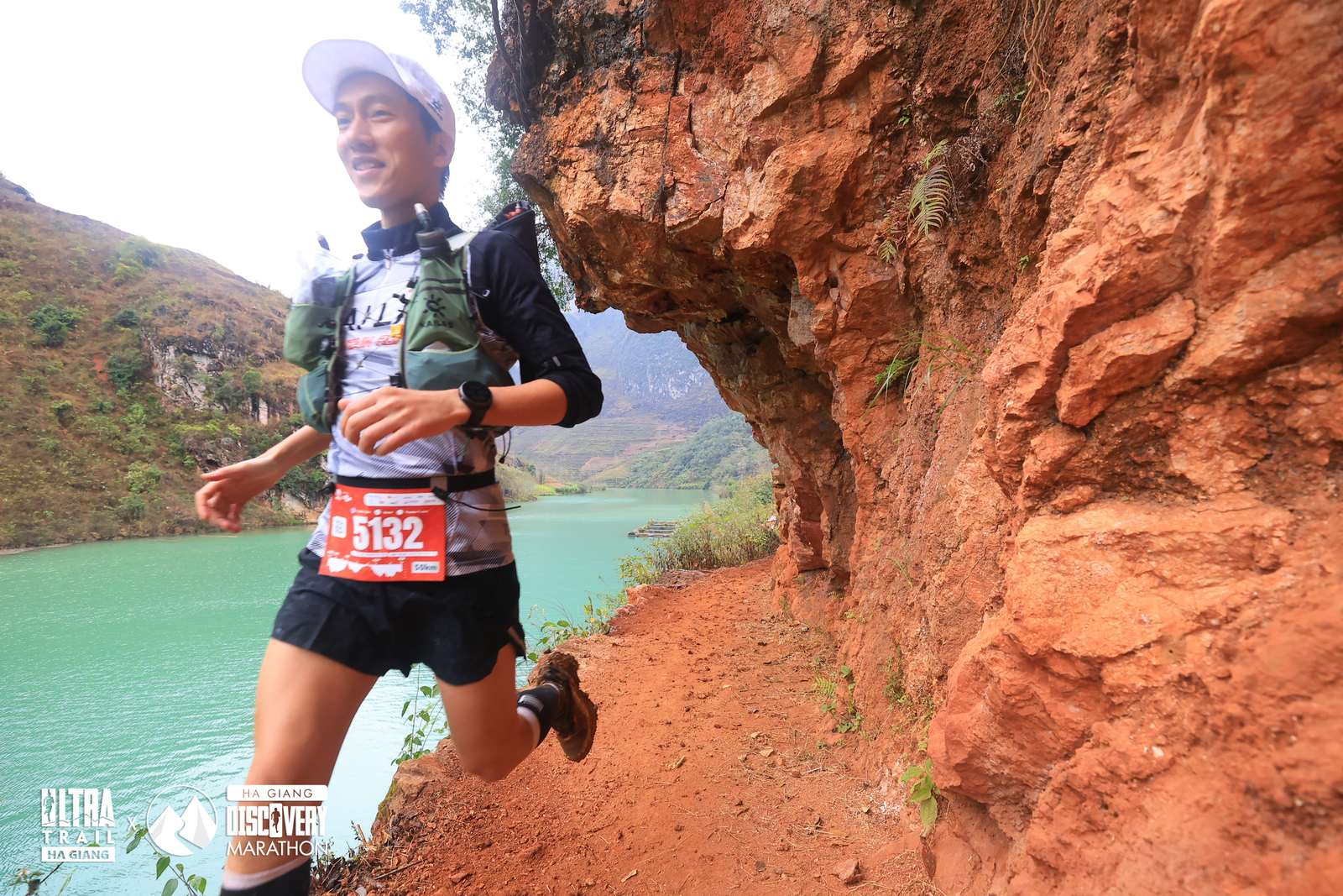 Runner chạy trail trên đường đất đỏ bên dòng sông xanh ngọc ở Hà Giang